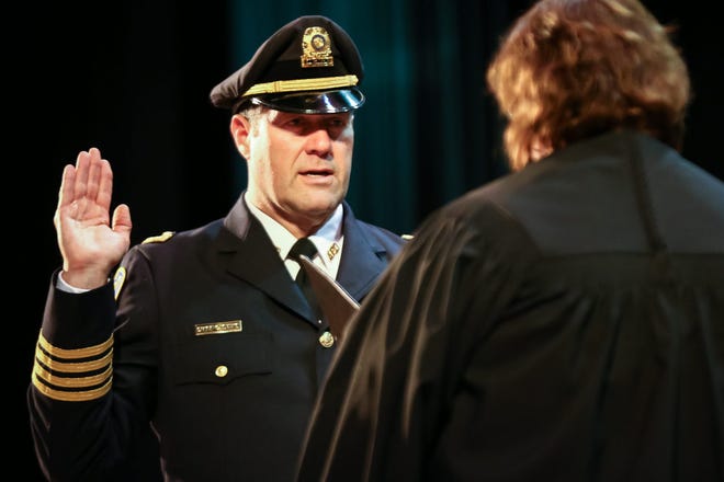 Craig Davis is sworn in as the new Ashland Police Chief during the Assumption of Command Ceremony at Ashland High School on Sunday.
