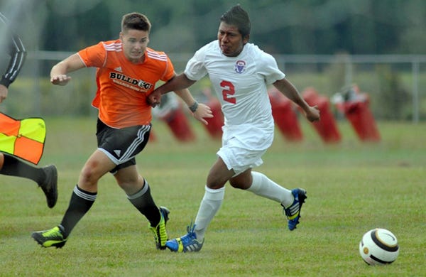 Philip Trappe (left) and Juan Carlos battle for the ball as during Wallace-Rose Hill's 6-0 win over Pender High School in Burgaw on Oct. 21, 2013.