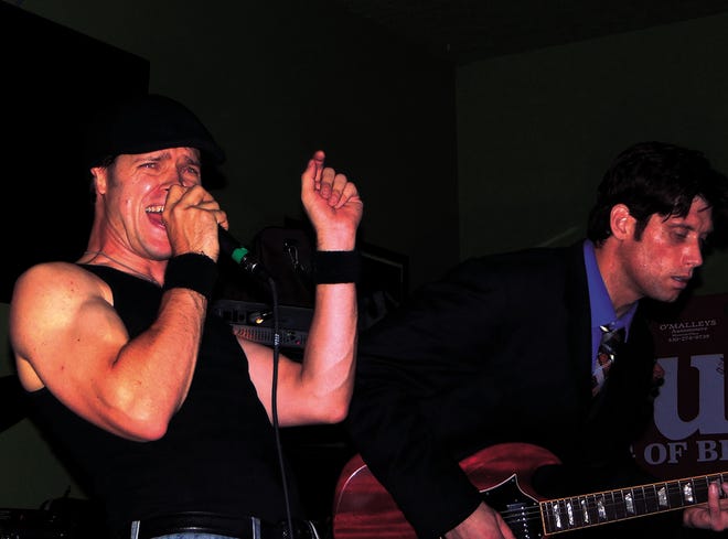 Ryan Cornell (left) sings and Dan Wessman plays the guitar during a Night Prowler show. The band will play at Martini 97 in Dover Nov. 1. Night Prowler is an AC/DC tribute band.