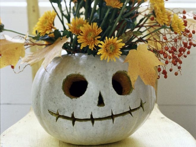 A floral arrangement in a pumpkin that is carved into a likeness of the animated character Jack Skellington from “The Nightmare Before Christmas.”
