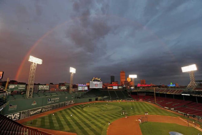 Charles Krupa Associated Press Red Sox players take batting practice as a rainbow appears in the sky above Fenway Park on Tuesday in Boston.