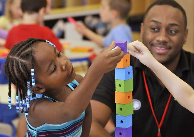 Left: Pre-kindergarten student Sydney H. plays with Stack Up! blocks as teacher Diraylin Milner looks on at the Goddard School. The students at the school participated in the Pre-schooler-Approved Toy Test designed to see which toys promoted learning and skills, while also providing the most entertainment. Photos by Will.Dickey@Jacksonville.com