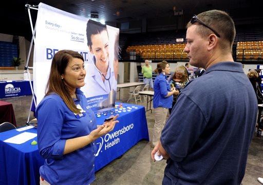 Registered nurse Salanda Bowman, left, talks with part-time Kentucky Wesleyan College student Jason Ward, of Whitesville, about job openings at the Owensboro Health Regional Hospital during a Regional Career and Job Fair in the Owensboro Sports Center in Owensboro, Ky. in this Oct. 1 photo.