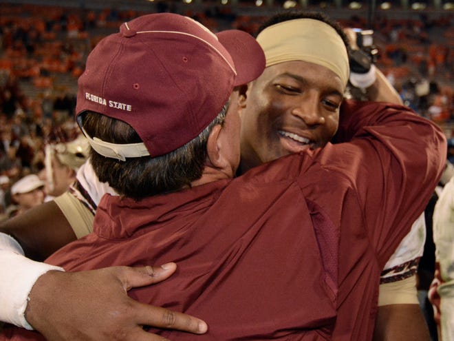 Florida State quarterback Jameis Winston, right, embraces Seminoles head coach Jimbo Fisher after FSU's 51-14 road win over Clemson on Saturday. (The Associated Press)