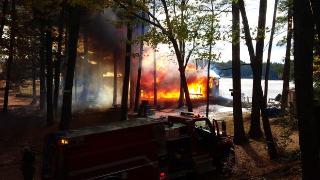 A blaze consumes a lakeside home on Starboard Lane, off 23rd Street Loop, in Shapleigh on Friday afternoon.