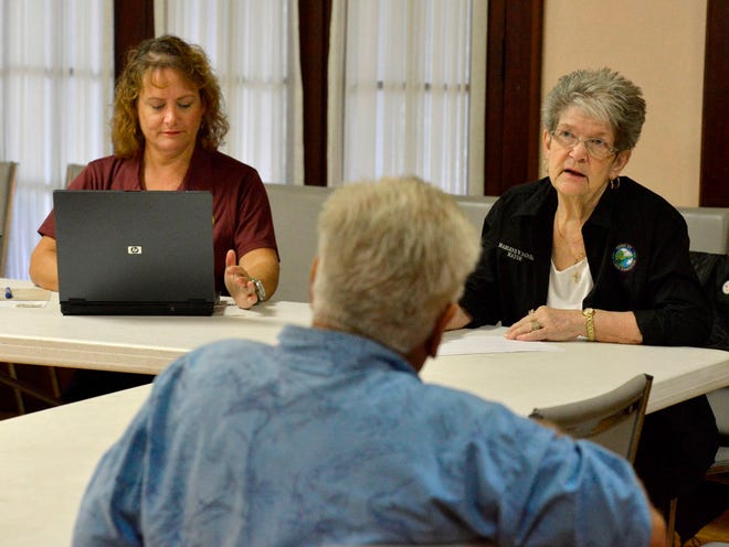 Lake Hamilton Mayor Marlene Wagner, right, and Sara Irvine, the town clerk, listen to questions from town resident Bob Howland during an informal meeting with the mayor at the Lake Hamilton Woman's Club on Thursday.