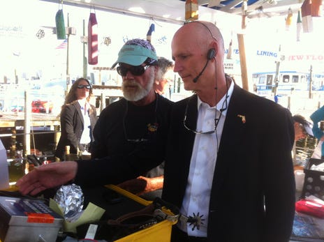 Weighmaster Bruce Cheves gives Gov. Rick Scott a chance to announce the time and weight of one of the fish entries Thursday afternoon. Scott’s campaign scrapped a $25,000-a-person alligator hunt, but was using Louisiana Gov. Bobby Jindal as bait for a $5,000-a-head fundraiser in Destin on Friday. The “Let’s Get to Work” committee, a fund-raising arm of Scott’s campaign, was to hold the event at the Emerald Grande in Destin, which will include dinner and fishing.