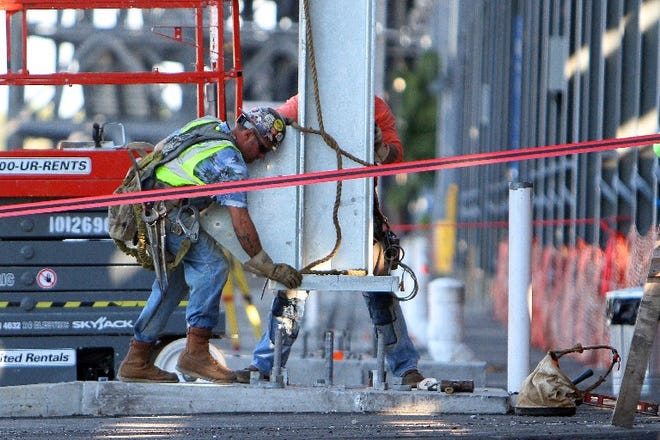 Construction workers on Friday connect steel to concrete pilings that are part of the Daytona Rising project to renovate the fronstretch grandstand at Daytona International Speedway.