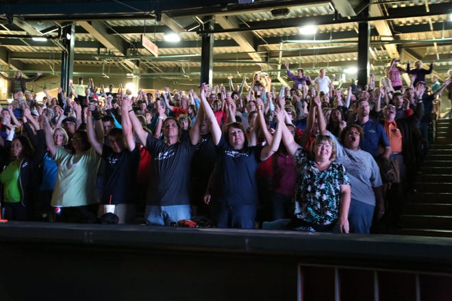 People join hands during the recent "As One Church: Some Assembly Required" ecumenical event at the Chickasaw Bricktown Ballpark in downtown Oklahoma City. Photo provided by Stephen Thomas of OKC Memories