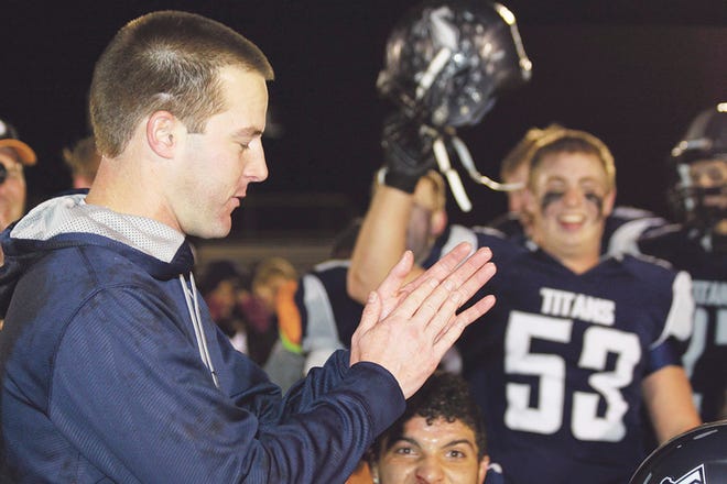 Annawan-Wethersfield Coach Brandon Johnston celebrates with his Titans after the game.