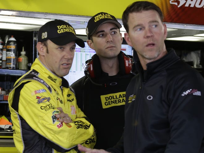 Matt Kenseth, left, talks with his crew during practice for the NASCAR Sprint Cup Series race at the Martinsville (Va.) Speedway on Saturday.