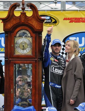 Don Petersen Associated Press Jimmie Johnson celebrates with his wife, Chandra, with one of his eight Martinsville grandfather clocks, given to winners at the fabled Virginia short track