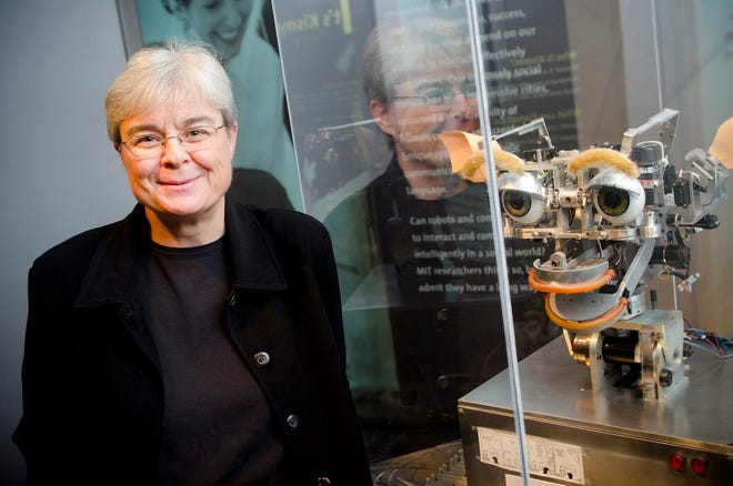 Dr. Debbie Douglas, Director of Collections and Curator of Science & Technology, is pictured with "Kismet," one of the most well known robots at the permanent MIT Museum exhibit called "Robots and Beyond."