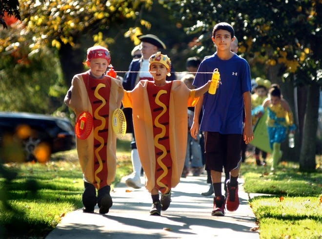 At last year's Mooresrtown Halloween Parade, Harry Cramer (from left), Ari Lodato and Yanni Lodato, all of Moorestown, lead the march along Main Street toward Stokes Hill.