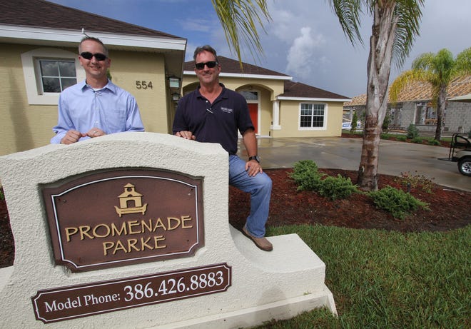 Owner of Paytas Homes, Jim Paytas, right, and company vice president Jim Mather, are seen outside a Paytas model home in New Smyrna Beach recently. Paytas’ father and uncle built homes in Volusia County in the early ’70s.