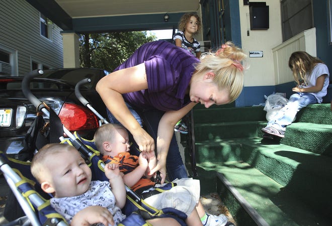 Laura Dahlweiner prepares to leave the day care where two of her kids are cared for while she works nearby in Daytona Beach on Aug. 29. Dahlweiner became homeless after moving to Florida and the father of her children walked out on them.