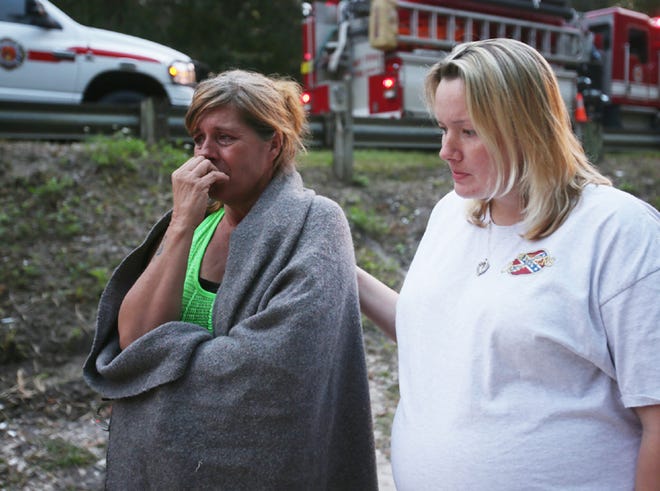 Rhonda Kilpatrick is consoled by her neice Krystal Kilpatrick after her boyfriend, Todd Clark, died after jumping off of a nearby bridge into the Econfina River on Sunday.