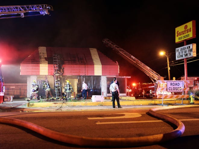 Firefighters extinguish a fire Monday night at the abandoned building that housed the former Sunrise Fried Chicken at Barrow and Honduras streets in Houma. The building caught fire about 8 p.m.