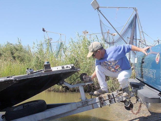 Dean Boudreaux, of Golden Meadow, picks up his boat Thursday at a launch in Golden Meadow.
