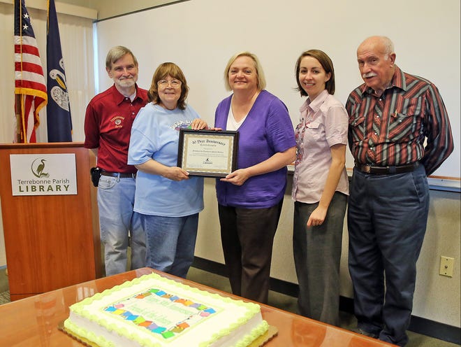 Terrebonne Parish Library Mary Cosper LeBoeuf (center) presents a commendation to Friends of the Terrebonne Public Library vice president Walter Collins (left), president Kathleen Landry, secretary Rachel LeCompte and treasurer Kenneth Royston at a Tuesday celebration of the organization’s 30th anniversary.