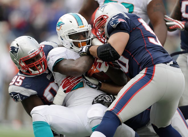 Patriots Chandler Jones (95) and Rob Ninkovich (50) held down running back Lamar Miller and the Dolphins in the second half Sunday.