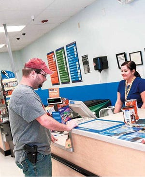 Hunter Brown talks with Darla McMahon in the automotive section of Walmart. Photo by Brett Roho for the Tulsa World