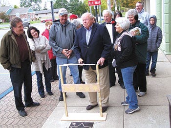 Bill Watson conducts a ceremonial ribbon cutting to dedicate his star in the Colon Magicians' Walk of Fame Saturday in downtown Colon.