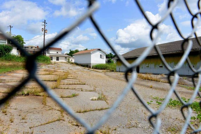 A portion of the Armstrong and Dobbs tract is seen through a chain-link fence on Monday, April 24, 2013.  (Richard Hamm/Staff) OnlineAthens / Athens Banner-Herald