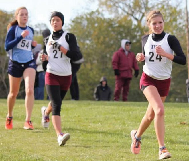 Molly Wang, left, and Camren Magee run for the finish line at regionals in Bureau Valley to help IVC advance to sectionals.