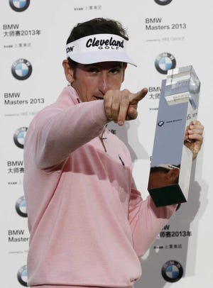 Spain's Gonzalo Fernandez-Castano gestures with his champion trophy during the award ceremony of the BMW Masters golf tournament at the Lake Malaren Golf Club in Shanghai, China, Sunday, Oct. 27, 2013. Fernandez-Castano finished on 11-under 277, one shot clear of Francesco Molinari (64) and Thongchai Jaidee (66). (AP Photo/Eugene Hoshiko)