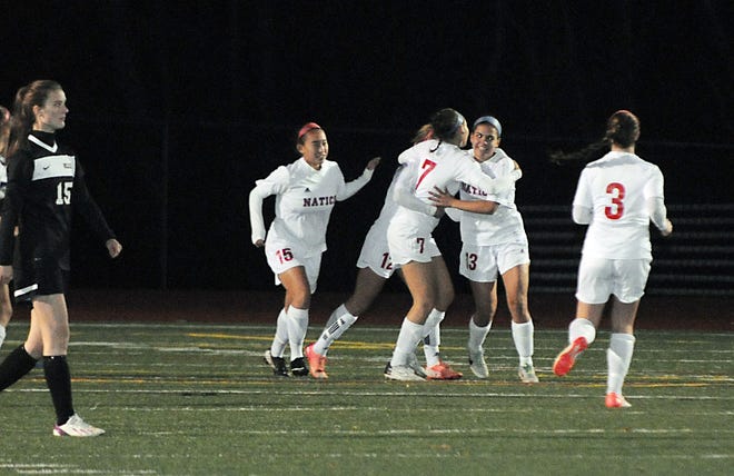 Natick players celebrate an early goal during the team's matchup against Wellesley on Monday evening.