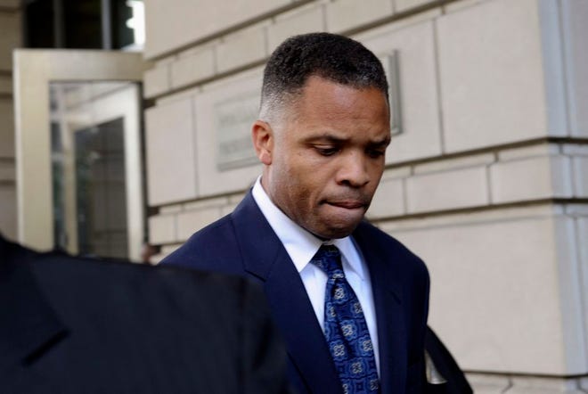 In this Aug. 14, 2913 file photo, former Illinois Rep. Jesse Jackson Jr., leaves federal court in Washington after being sentenced to 2 1/2 years in prison for misusing $750,000 in campaign funds. A Bureau of Prisons spokesperson said Tuesday, Oct. 29, 2013, that Jackson has reported to a federal prison in North Carolina to serve his term.