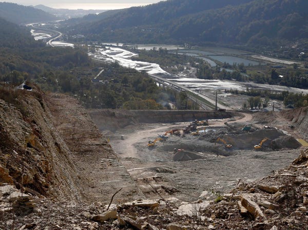 Excavators move earth near Akhshtyr vilage in Sochi, Russia, on Thursday. (Dmitry Lovetsky | Associated Press)