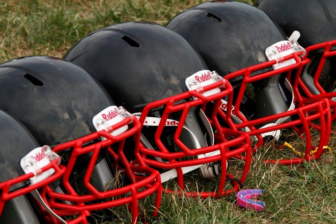 This Aug. 4, 2012 file photo shows new football helmets that were given to a group of youth football players from the Akron Parents Pee Wee Football League, in Akron, Ohio. It's not just football. A new report says too little is known about concussion risks for young athletes, and it's not clear whether better headgear is an answer. The panel stresses wearing proper safety equipment. But it finds little evidence that current helmet designs, face masks and other gear really prevent concussions, as ads often claim.