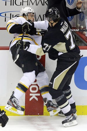 Evgeni Malkin checks Daniel Paille during the Penguins' win over the Bruins on Wednesday.