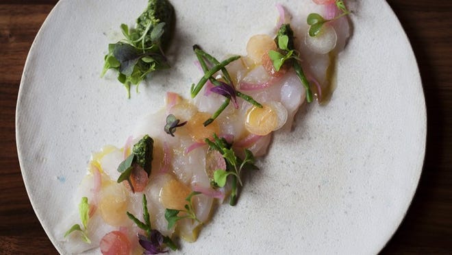 The black bass crudo with pickled red onion, local melon, and cilantro pesto is shown at The Grove restaurant in Delray Beach. (Laura McDermott/The Palm Beach Post).