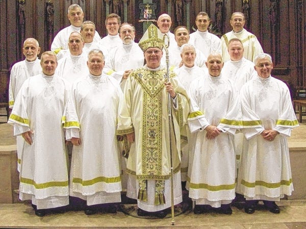 Newly ordained permanent deacons gather with Fall River Diocese Bishop George W. Coleman after their ordination.