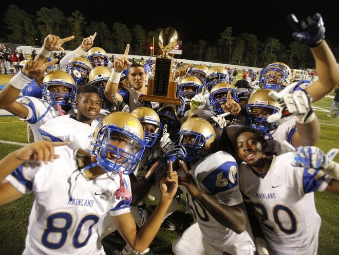 Mainland players celebrate their victory over rival Seabreeze at Municipal Stadium in Daytona Beach on Friday.