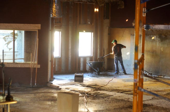 Cory Hodapp, owner of the building that housed The Rome restaurant at 114 S. Ninth St., removes material from the floor of the building frIday.