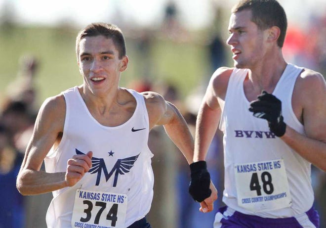 Blue Valley Northwest's Sam Quinn, right, glances over at Manhattan's Chris Melgares, left, as Melgares passes him to take second place at Saturday morning's 6A boys state cross country meet in Lawrence.