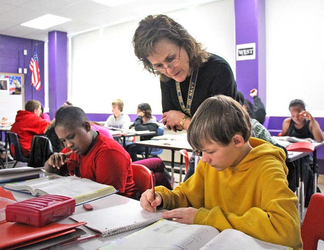 Mathematics teacher Donna McGinty works with a class of seventh-graders at Eisenhower Middle School on Thursday afternoon. Eisenhower and Ross Elementary use a joint campus system to make sure younger students don't get lost in the evolution to middle school.