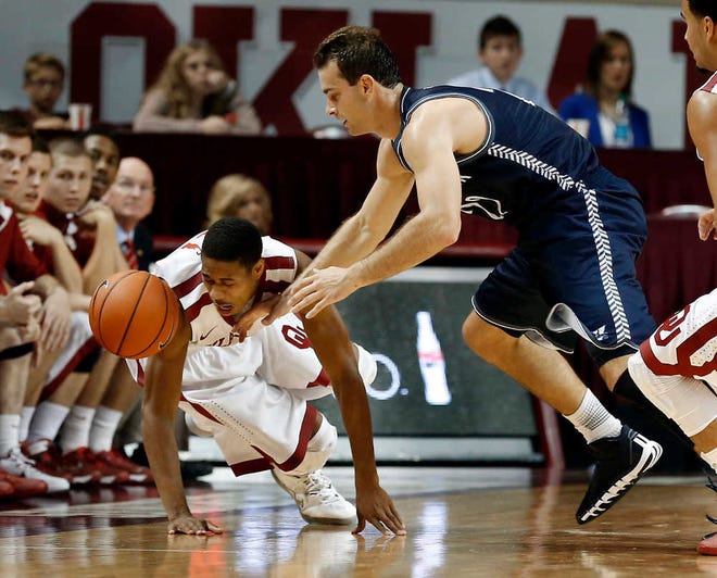 Oklahoma's Isaiah Cousins, left, and Washburn's Alex North scramble for the ball during Saturday's exhibiton game.