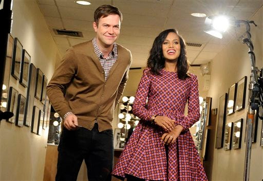 In this Oct. 29, 2013, file photo released by NBC, actress Kerry Washington, right, stands with cast member Taran Killam during a promotional shoot for "Saturday Night Live," in New York. After receiving criticism recently for its lack of a black female cast member, the show on Saturday, Nov. 2, 2013, opened with a skit where guest host Washington portrayed Michelle Obama, then Oprah Winfrey. She was asked to change into a Beyonce outfit - before executive producer Lorne Michaels stepped in.