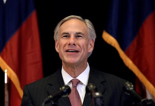 Texas Attorney General Greg Abbott smiles as he responds to a reporter's questions during a news conference Monday in Dallas.