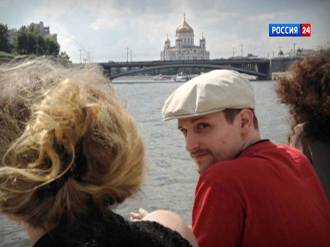 In this video frame grab provided by LifeNews via Rossia 24 TV channel, which has been authenticated based on its contents and other AP reporting, former National Security Agency systems analyst Edward Snowden looks over his shoulder during a boat trip on the Moscow River in Moscow, with the Christ the Savior Cathedral in the background. The White House and the leaders of the congressional intelligence committees are rejecting Snowden's plea for clemency.