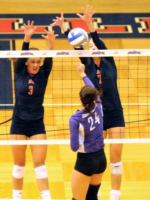 Hope volleyball's Mari Schoolmaster (3) and Jenna Grasmeyer (7) go up for a block Saturday afternoon at the DeVos Fieldhouse.