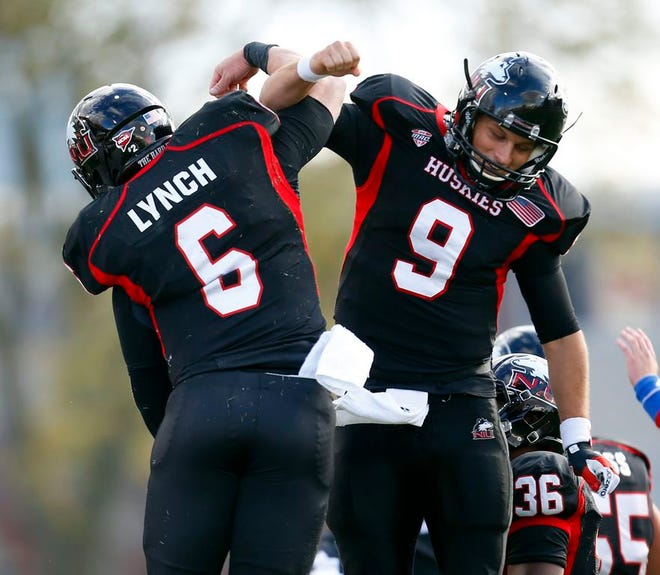 Northern Illinois quarterback Jordan Lynch (6) celebrates with teammate quarterback Matt McIntosh (9) after Lynch scored a touchdown during the first half of an NCAA college football game against Eastern Michigan on Saturday, Oct. 26, 2013, in DeKalb, Ill. (AP Photo/Jeff Haynes)