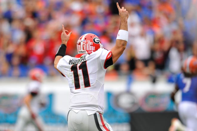 Georgia quarterback Aaron Murray (11) celebrates a touchdown during the first half of the NCAA college football game between Georgia and Florida in Jacksonville, Fla., Saturday, Nov. 2, 2013.