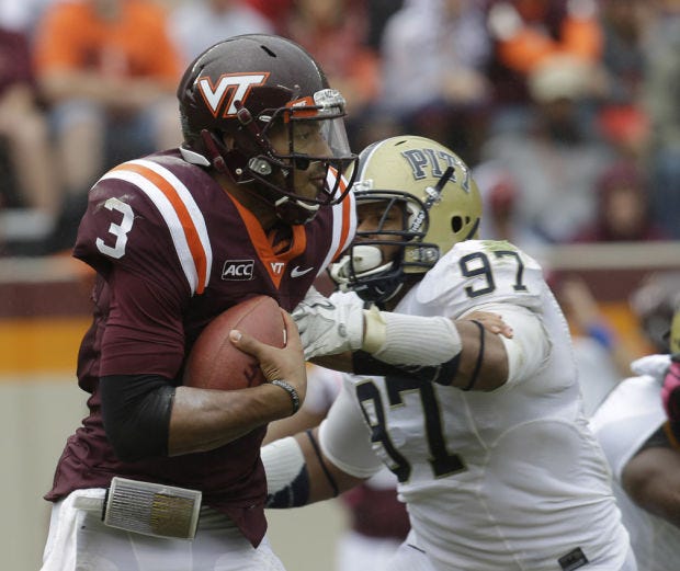 Virginia Tech quarterback Logan Thomas (3) is pressured by Pittsburgh defensive lineman Aaron Donald (97) during the second half of an NCAA college football game in Blacksburg, Va., Saturday, Oct. 12, 2013. Tech won the game 19-9. (AP Photo/Steve Helber)