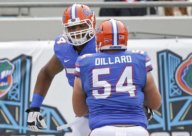 John Raoux Associated Press Florida offensive linemen Trenton Brown (background) and Cameron Dillard warm up before Saturday's game against Georgia at EverBank Field.